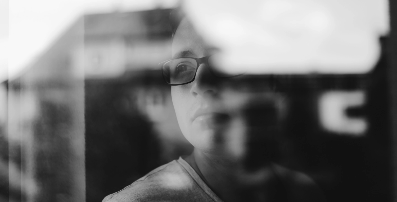 Svartvit närbild, kvinna ser ut genom fönster, framtid it arbetsliv