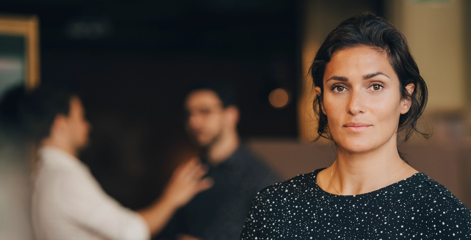 Kvinna med prickig blus i kontor.webp